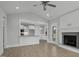 Open floor plan with a fireplace, kitchen bar, and light wood flooring at 163 S Harper Faith Way, Benson, NC 27504
