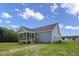 Exterior of home featuring gray siding, a screened-in porch, and lush green backyard, perfect for outdoor living at 163 S Harper Faith Way, Benson, NC 27504