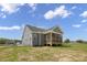 Exterior of home with gray siding and a screened-in porch, set against a backdrop of clear blue skies at 163 S Harper Faith Way, Benson, NC 27504