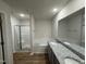 Spa-like bathroom featuring a double vanity, soaking tub, and glass-enclosed shower at 170 Eason Creek Way, Clayton, NC 27527