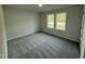 Carpeted bedroom with natural light coming from the two picture frame windows at 170 Eason Creek Way, Clayton, NC 27527