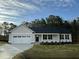 Inviting one-story home with a manicured lawn, two-car garage, and stylish exterior paint at 170 Eason Creek Way, Clayton, NC 27527