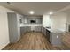 Well-lit kitchen featuring sleek gray cabinets, granite countertops, and stainless steel appliances at 170 Eason Creek Way, Clayton, NC 27527