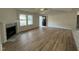 Bright living room with wood floors, a fireplace, and a view to the entry door and outside at 170 Eason Creek Way, Clayton, NC 27527
