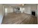 Open-concept living area with wood floors, fireplace, kitchen with island, and access to the outdoors at 170 Eason Creek Way, Clayton, NC 27527