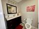 This bathroom features a large dark vanity with a modern sink and neutral paint at 1802 Greenbriar Rd, Henderson, NC 27536