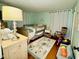 The bedroom offers hardwood floors, soft mint walls, and a crib with guard rail at 1802 Greenbriar Rd, Henderson, NC 27536