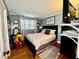 This is a cozy bedroom with blue walls, hardwood floors, and a nice window with natural light at 1802 Greenbriar Rd, Henderson, NC 27536