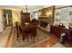 Inviting dining room with a large table, stone fireplace, and hardwood floors at 1802 Greenbriar Rd, Henderson, NC 27536
