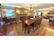 Spacious dining room featuring a stone fireplace, hardwood floors, and an elegant chandelier at 1802 Greenbriar Rd, Henderson, NC 27536