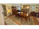 Inviting dining room with a stone fireplace, chandelier, and wooden table set for eight at 1802 Greenbriar Rd, Henderson, NC 27536