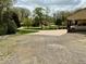 Long driveway with ample parking and lush landscaping leading to a well-maintained home at 1802 Greenbriar Rd, Henderson, NC 27536