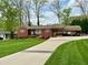 Charming single-story red brick home with well-manicured lawn and inviting curb appeal at 1802 Greenbriar Rd, Henderson, NC 27536
