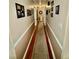 Hallway with picture-frame molding and a decorative carpet runner at 1802 Greenbriar Rd, Henderson, NC 27536
