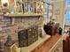 Cozy living room featuring a stone fireplace and seasonal decor at 1802 Greenbriar Rd, Henderson, NC 27536