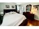 Cozy main bedroom with a full bed, wooden dresser, and hardwood floors at 1802 Greenbriar Rd, Henderson, NC 27536