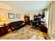 Office space features a black sofa, office chair, and a wooden desk at 1802 Greenbriar Rd, Henderson, NC 27536