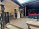 Covered patio with a dining area, potted plants, and access to the backyard at 1802 Greenbriar Rd, Henderson, NC 27536