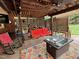 Cozy outdoor living area with comfortable seating, an outdoor fan, and a coffee table at 1802 Greenbriar Rd, Henderson, NC 27536