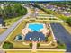 An aerial view of a community pool and clubhouse, with a parking lot and playground nearby at 181 Fawn Hill Ct, Garner, NC 27529