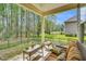 Relaxing back porch with comfortable seating and a view of the serene backyard at 181 Fawn Hill Ct, Garner, NC 27529