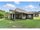 Green backyard showing the covered patio, fencing, and house elevation at 181 Fawn Hill Ct, Garner, NC 27529