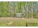 Well-kept backyard featuring a shed surrounded by lush greenery and mature trees at 181 Fawn Hill Ct, Garner, NC 27529