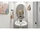 Charming half bath with pedestal sink, decorative mirror, and neutral wall color at 181 Fawn Hill Ct, Garner, NC 27529