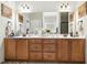 Bright bathroom with double vanity, white countertop, and modern mirrors at 181 Fawn Hill Ct, Garner, NC 27529