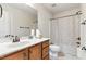 Bathroom with a single vanity, light wood cabinets, and a shower-tub combo with a shower curtain at 181 Fawn Hill Ct, Garner, NC 27529