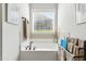 Soaking tub with window and towel racks in bright bathroom at 181 Fawn Hill Ct, Garner, NC 27529