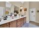 Bathroom with double sink vanity, large mirror, decorative wall art, and neutral color scheme at 181 Fawn Hill Ct, Garner, NC 27529