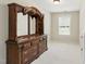 Bedroom featuring a large, decorative wood dresser with storage space, in a neutral room with natural light at 181 Fawn Hill Ct, Garner, NC 27529