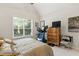 Comfortable bedroom featuring a window, wooden dresser, and treadmill with a TV on the dresser at 181 Fawn Hill Ct, Garner, NC 27529
