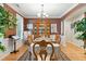Elegant dining room featuring hardwood floors, wainscoting, and a large china cabinet at 181 Fawn Hill Ct, Garner, NC 27529