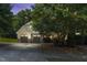 Charming two-story home featuring a two-car garage and a beautifully landscaped front yard at twilight at 181 Fawn Hill Ct, Garner, NC 27529
