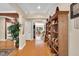 Inviting foyer with hardwood floors, a large bookcase, and views into the dining room at 181 Fawn Hill Ct, Garner, NC 27529