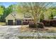 Charming two-story home featuring a well-manicured lawn, mature tree, and inviting curb appeal with a two car garage at 181 Fawn Hill Ct, Garner, NC 27529