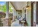 Relaxing front porch with comfortable seating, decorative pillows, and a charming side table at 181 Fawn Hill Ct, Garner, NC 27529
