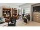 Bright home office space featuring built-in bookshelves, a desk setup, and natural light from a window at 181 Fawn Hill Ct, Garner, NC 27529
