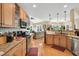 Well-equipped kitchen with wooden cabinetry, and a view of the cozy sitting area, ideal for cooking and relaxing at 181 Fawn Hill Ct, Garner, NC 27529