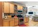 A well-lit kitchen featuring custom wood cabinets, granite countertops, and stainless steel appliances at 181 Fawn Hill Ct, Garner, NC 27529