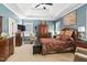 Spacious main bedroom featuring a tray ceiling, sitting area, and large windows at 181 Fawn Hill Ct, Garner, NC 27529