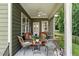 Cozy covered porch featuring wicker furniture and potted plants at 181 Fawn Hill Ct, Garner, NC 27529