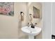 Quaint powder room with pedestal sink and decorative mirror, maximizing space and charm at 181 Fawn Hill Ct, Garner, NC 27529