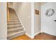 Carpeted stairs with wooden handrail and a white door at 181 Fawn Hill Ct, Garner, NC 27529