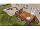 Aerial view of the backyard featuring an upper wood deck, a patio with furniture, and grassy area at 189 Grey Hawk Dr, Garner, NC 27529