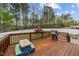 A wooden backyard deck with a grill and table overlooking a fenced yard with a playset at 189 Grey Hawk Dr, Garner, NC 27529