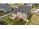Aerial view of fenced backyard including a wood deck, patio with outdoor seating, and playground area at 189 Grey Hawk Dr, Garner, NC 27529