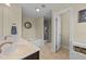 Well-lit bathroom features double sinks, a soaking tub, a stand-up shower, and stylish fixtures at 189 Grey Hawk Dr, Garner, NC 27529